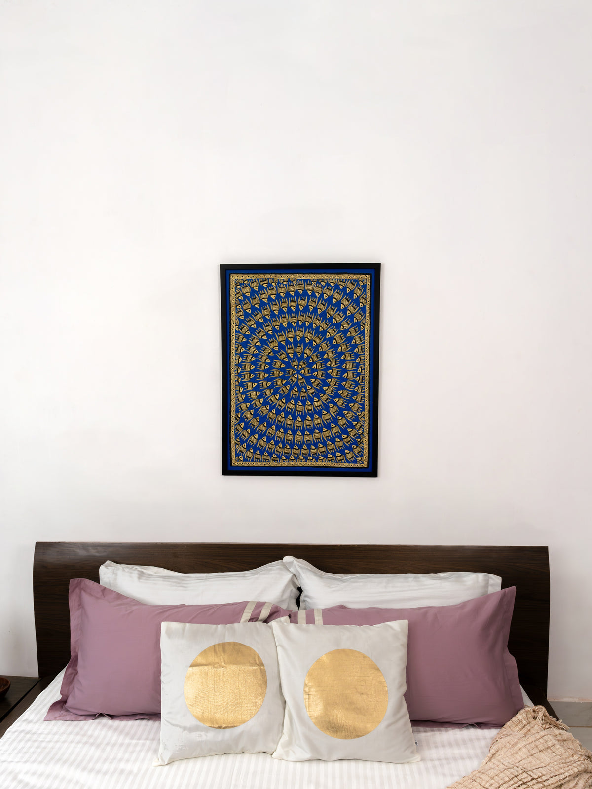 Countless fish flowing in rhythmic repetition across a blue Madhubani canvas