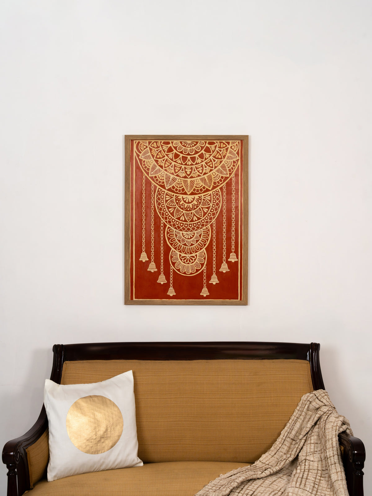 Delicate clay chains and bells cascading from a Lippan mandala