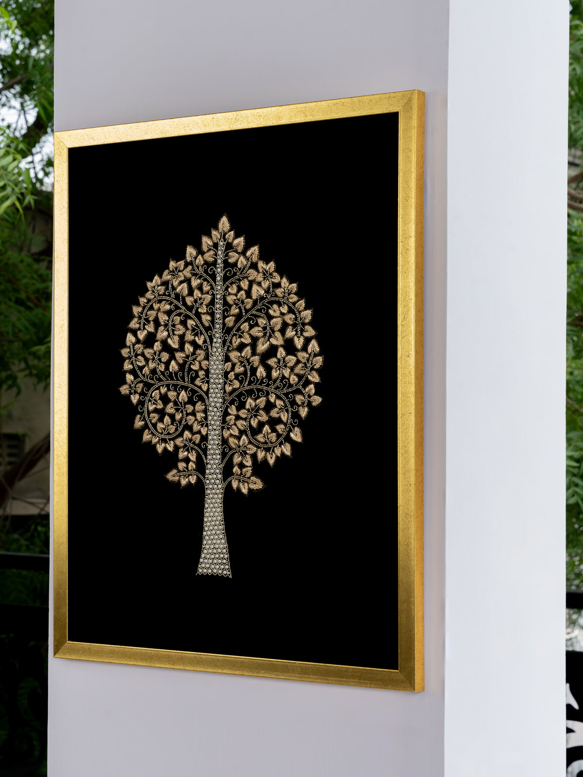 Detail of raised zari embroidery catching light across the velvet surface