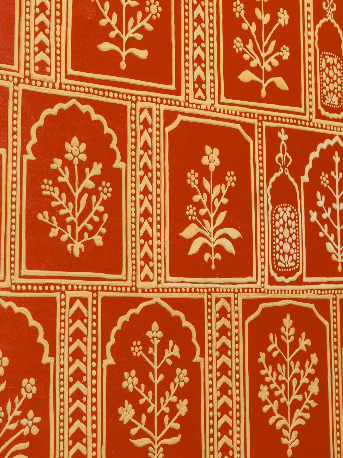 Detail of raised clay cartouches and inset mirror in Lippan work